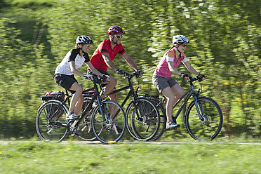 Germany, Bavaria, Man and women riding bicycle - DSF000560