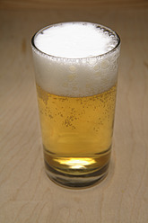 Beer glass on table, close up - TCF002328