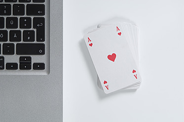 Laptop and ace of heart on white background - ASF004524