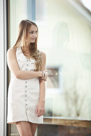 Germany, Bavaria, Young woman looking away, smiling stock photo