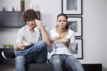 Germany, Bavaria, Young couple watching TV - MAEF004630