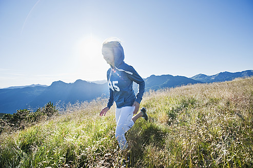 Austria, Salzburg County, Young woman running in alpine meadow - HHF004053