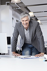 Germany, Bavaria, Munich, Mature man in office, smiling, portrait - RBYF000052