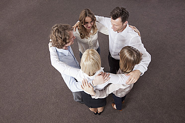 Germany, Bavaria, Munich, Group of colleagues in huddle - RBYF000090