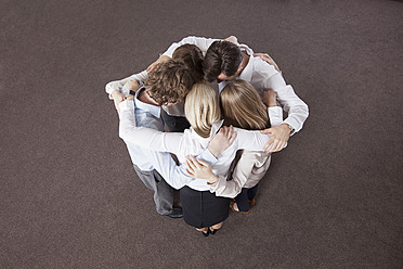 Germany, Bavaria, Munich, Group of colleagues in huddle - RBYF000091