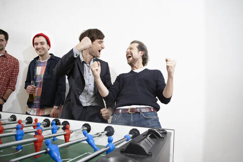 Germany, Cologne, Men playing table soccer stock photo