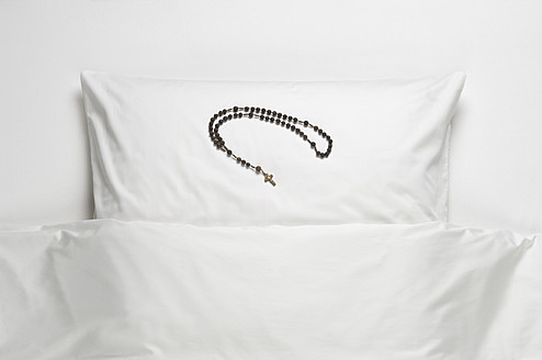 Rosary beads on bed - CRF002192