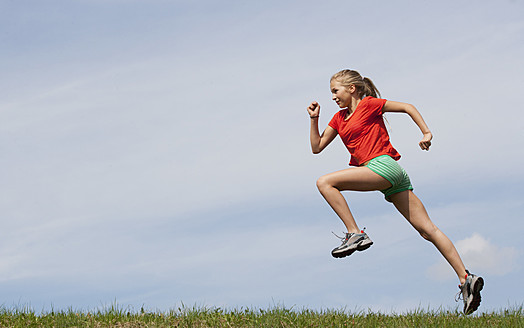 Austria, Teenage girl running on grass - WWF002339