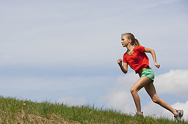 Sport Teenage Girl Running Outdoor. Young Woman Running In Field