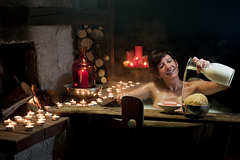 Austria, Salzburg County, Young woman taking bath in wooden tub - HHF004172