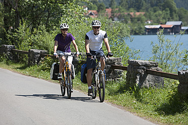 Deutschland, Bayern, Mann und Frau radeln am Walchensee - DSF000580