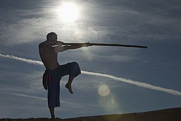 Germany, Bavaria, Young man doing martial arts training with stick - MAEF004675