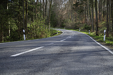 Germany, Bavaria, Empty forest road in spring - TCF002550