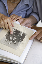 Germany, Bavaria, Senior couple with photo album - TCF002571