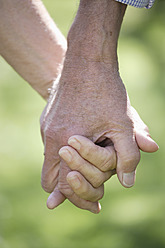 Germany, Bavaria, Senior couple holding hands, close up - TCF002587