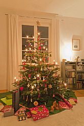 Germany, Baden Wuerttemberg, Stuttgart, Christmas gift under christmas tree - WDF001250