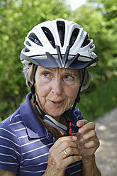 Deutschland, Bayern, Seniorin mit Fahrradhelm, Nahaufnahme - TCF002632