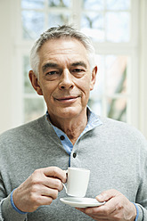 Germany, Berlin, Senior man with coffee cup, portrait - FMKYF000001