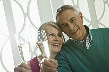 Germany, Berlin, Senior couple drinking champagne - FMKYF000058