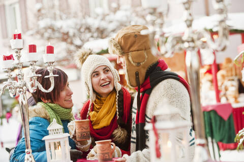 Austria, Salzburg, Man and women at christmas market, smiling stock photo