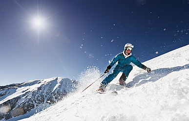 Österreich, Salzburg, Junger Mann beim Skifahren am Berg - HHF004188