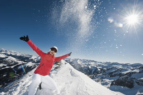Österreich, Salzburg, Junge Frau auf dem Gipfel eines Berges, lizenzfreies Stockfoto