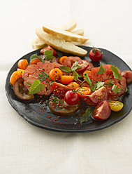 Tomato salad in plate, close up - KSWF000842
