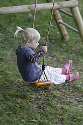 Germany, Bavaria, Girl playing on swing - TCF002708