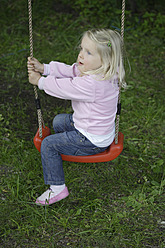 Germany, Bavaria, Girl playing on swing - TCF002709