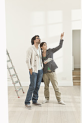 Germany, Berlin, Mature couple inspecting new house - FMKYF000151