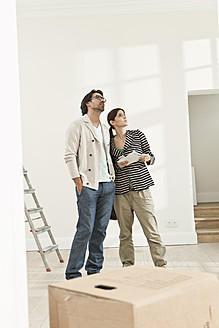 Germany, Berlin, Mature couple inspecting new house - FMKYF000152