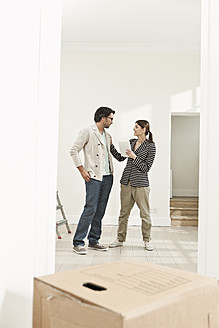 Germany, Berlin, Mature couple inspecting new house - FMKYF000153