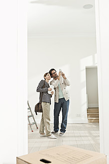 Germany, Berlin, Mature couple inspecting new house - FMKYF000154