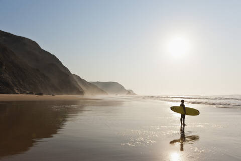 Portugal, Surfer on beach stock photo