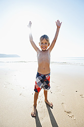 Portugal, Boy standing on beach, smiling - MIRF000497