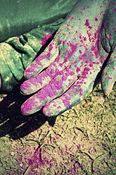 India, Ahmedabad, Young woman holding powder paint on holi festival - MBEF000365