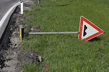 Germany, Bavaria, Bumps ahead sign lying on grass - TCF002721