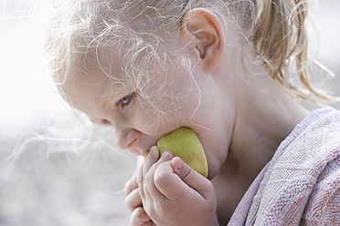 Germany, Bavaria, Girl eating apple, close up - TCF002785