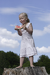 Germany, Bavaria, Girl eating piece of watermelon - TCF002772