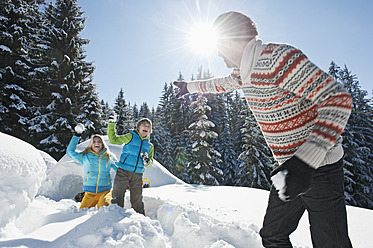 Austria, Salzburg County, Family playing near igloo - HHF004238