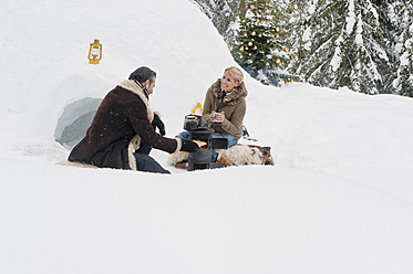 Austria, Salzburg County, Couple sitting near camping stove - HHF004297