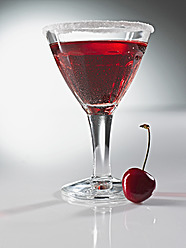 Glass of cherry martini with sugar crust, close up - KSWF000995