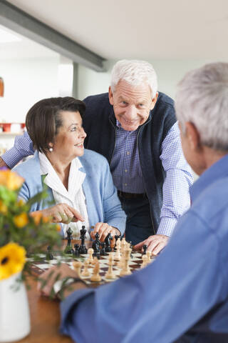 Germany, Leipzig, Senior men and woman playing chess stock photo