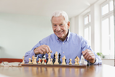Germany, Leipzig, Senior man playing chess game - WESTF018755