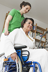 Deutschland, Leipzig, Ältere Frau sitzt im Rollstuhl, während eine andere Frau schiebt - WESTF018838