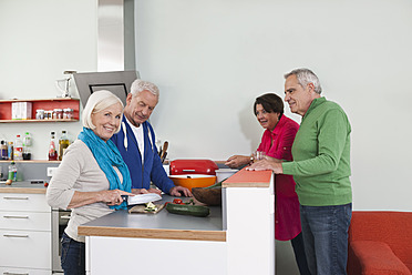 Germany, Leipzig, Senior men and women cooking food - WESTF018895
