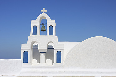 Greece, Santorini, Whitewashed traditionally Greek bell tower and cross in Oia - RUEF000984