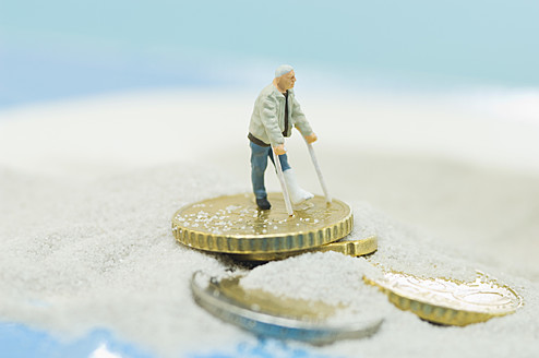 Figurines of handicapped patient on beach with euro coin - ASF004578