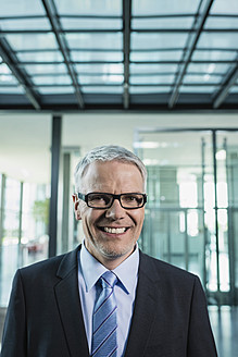 Germany, Stuttgart, Businessman smiling, portrait - MFPF000206