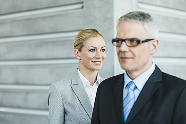 Germany, Stuttgart, Business people in office lobby, smiling - MFPF000226